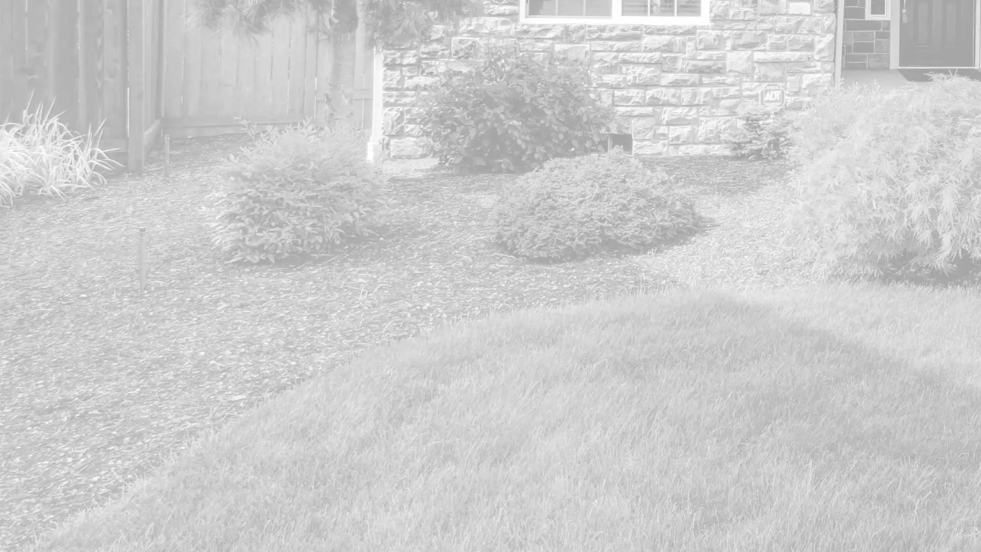 New mulch installed in a landscaping bed in front of a house in Clarklake.